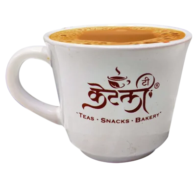 KT-dum-tea-Photoroom Aesthetic white ceramic tea cup with Kettly branding filled with traditional Indian masala chai.
